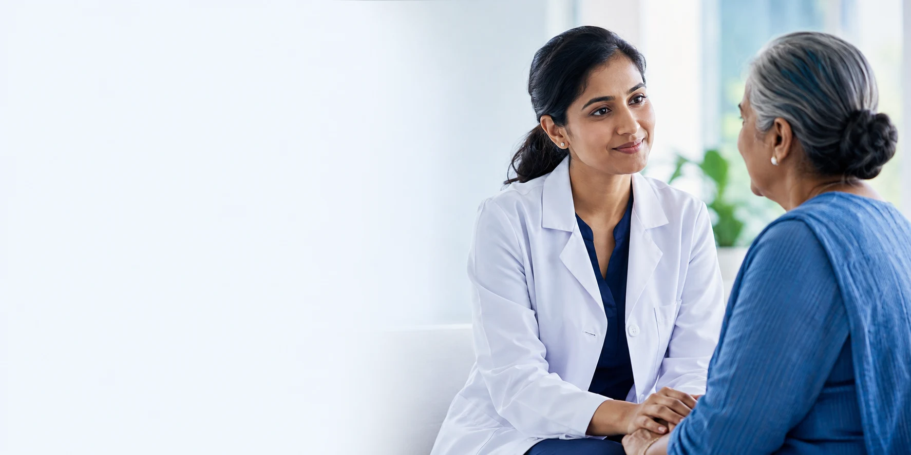 Illustrative healthcare scene of a doctor listening attentively to an older woman
